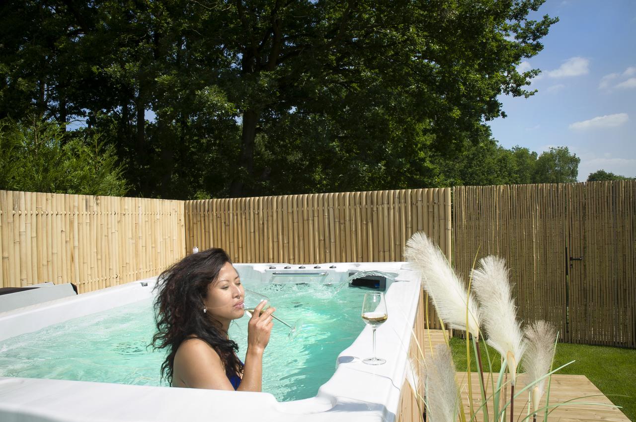 A woman drinking wine in the hot tub of B & B House of Java in Heusden-Zolder, Belgium