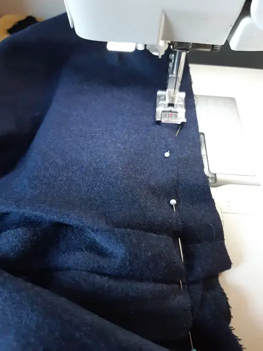 Blue fabric being sewn by machine to make a mattress topper Kenya