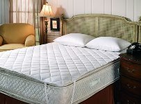 A sleeping mattress with mattress pad