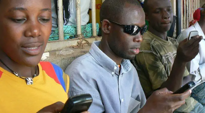 People using mobile phones in Uganda