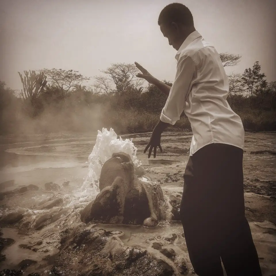Nkundwa plays around at the geyser, Sempaya Springs, Semuliki National Park, Uganda