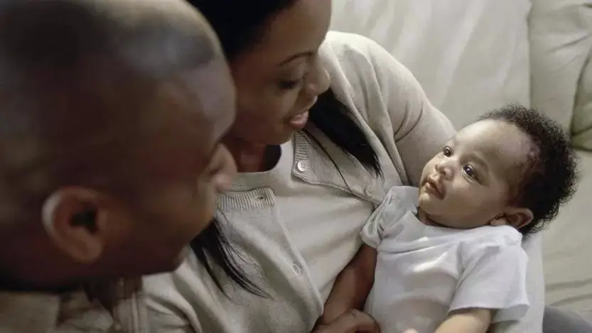 A black couple with a black baby