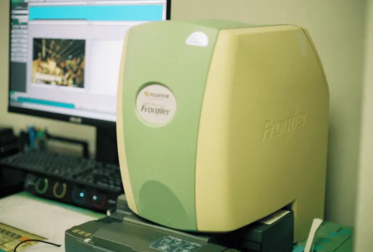 Film scanner and film lab software open on a monitor