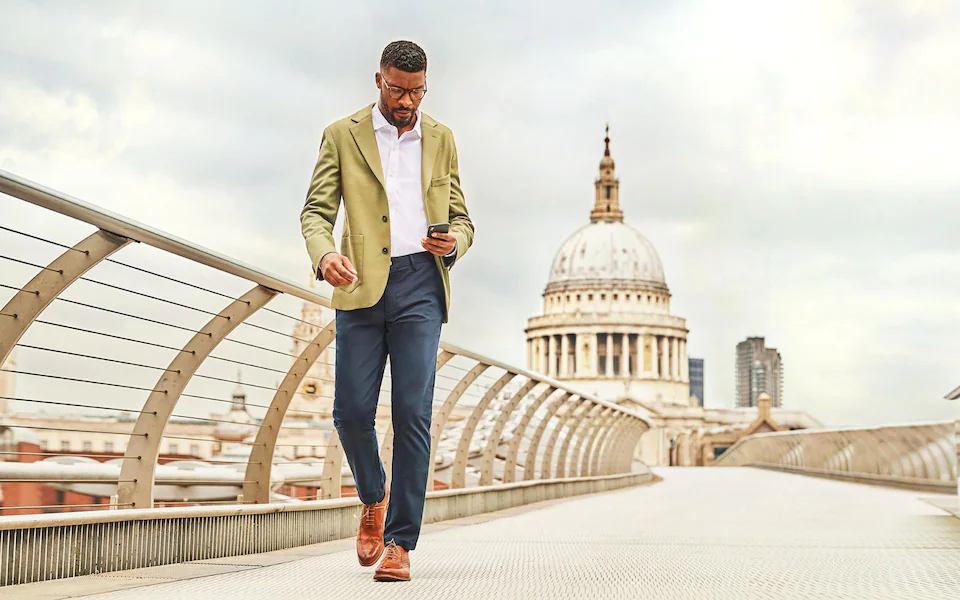 a man on a bridge wearing some of the best clothing brands mens