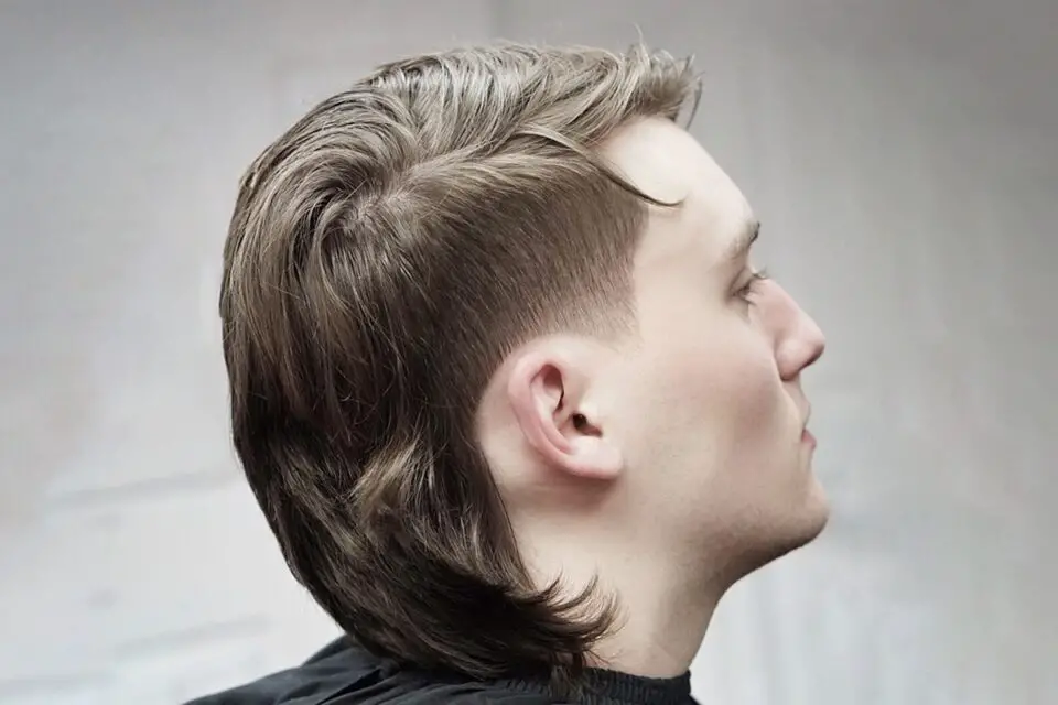 A hairstyle that has longer hair in back and shorter in front