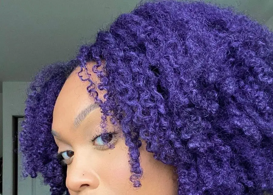 Hair colored with purple coloured wax for hair