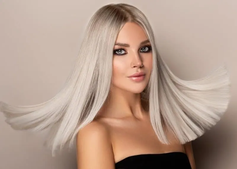 shadow root blonde straight hair with a blunt cut (very light blonde)