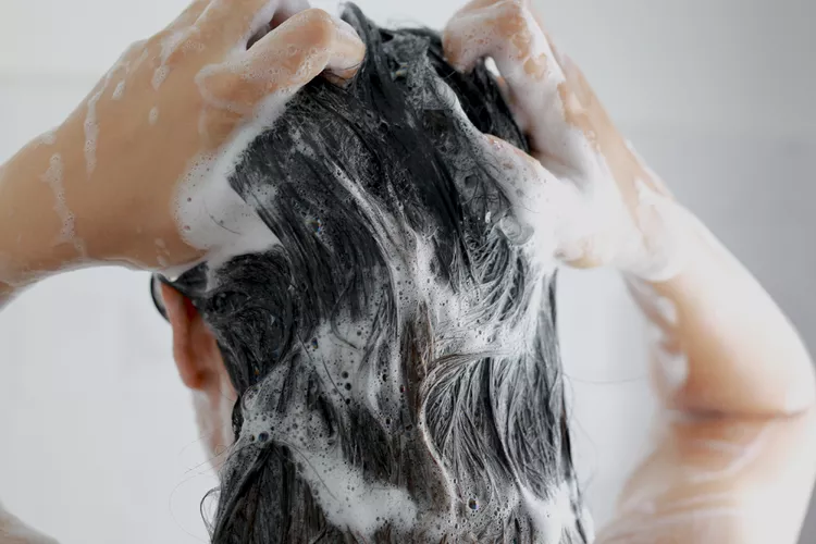 Ketoconazole Shampoo Side Effects: a woman shampooing her hair